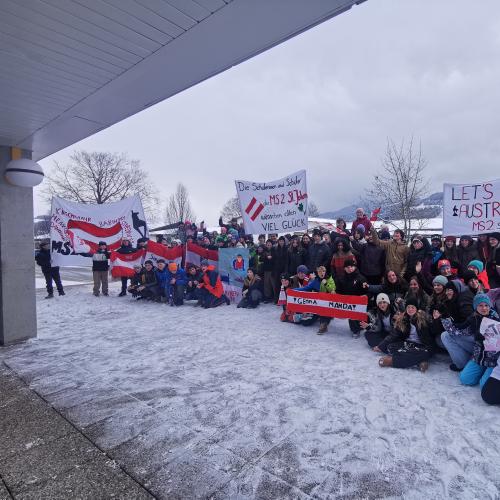 Schuklassen präsentieren stolz ihre Plakate fürs Hahnenkammrennen.-