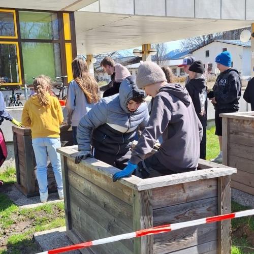 Schüler:innen beim Vorbereiten und Befüllen der Hochbeete