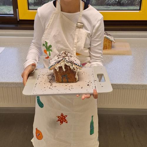 Schülerin präsentiert ihr Lebkuchenhaus